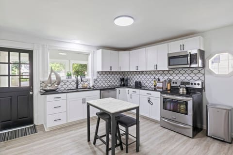Modern kitchen with stainless steel appliances and chic backsplash ️✨ Perfect for preparing meals during your stay in Canandaigua.
