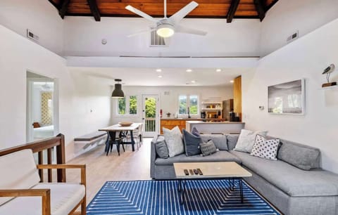 Top Level Living Area with comfortable sectional seating, TV, and an open layout perfect for gathering and relaxing. (Fireplace not operable)