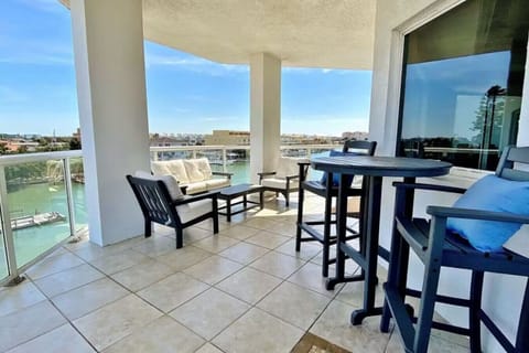 Bar-height seating by floor-to-ceiling windows, offering a scenic perch for coffee or cocktails.