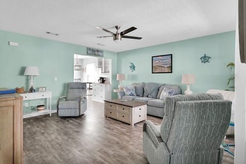 Large living room space with comfortable seating and smart TV
