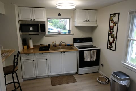 stove, oven, microwave and sink, fans in living room and kitchen