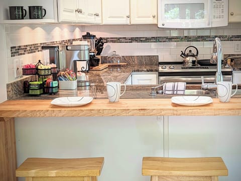 The breakfast bar is granite and pine with seating for four adults.