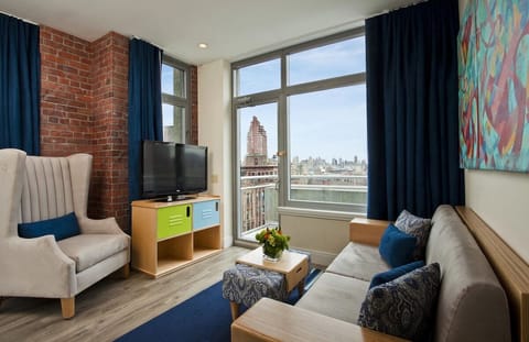 Unwind on the plush sofa while city lights glow outside.