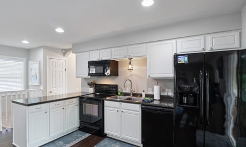Fully equipped kitchen with modern appliances, ample counter space, and stylish cabinetry—perfect for preparing meals during your stay.