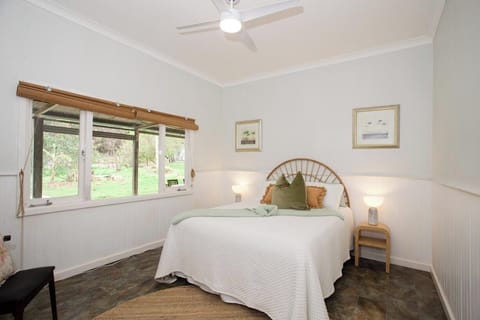 Rest in a tranquil bedroom with cozy bed and artwork.