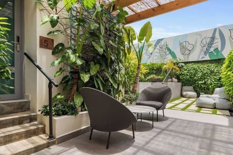 Immerse yourself in a world of charm and whimsy. Our vibrant exterior welcomes you with a sparkling pool, open-air gym, and delightful signage at every turn.