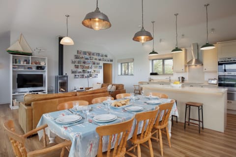 Open plan kitchen/dining/living area in Main House with smart TV and wood burner