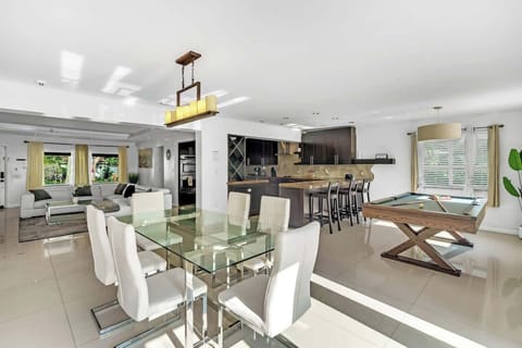 Open-concept space with pool table—perfect for vacation rentals and short-term stays. Enjoy stylish dining, modern kitchen, and game zone ideal for entertaining, family fun, or remote work.