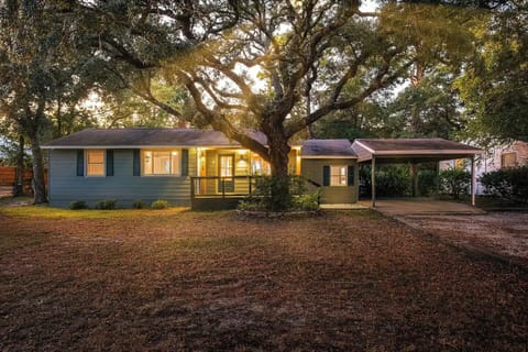 Front of the house: small deck, carport, and long driveway with room for 4 cars