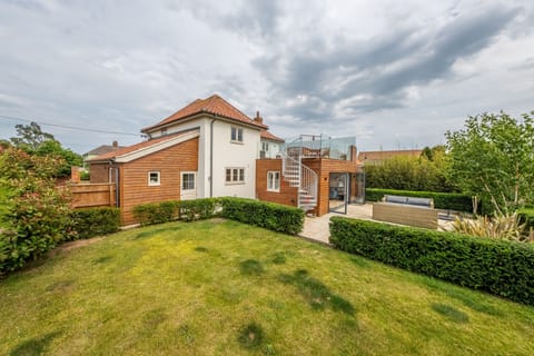 Guardian House, Burnham Market: Enclosed garden looking back to house with balcony and patio