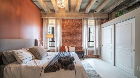 Stylish bedroom with a comfortable queen-sized bed, warm tones, and soft lighting, offering a peaceful retreat for a restful night’s sleep.
