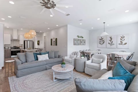 Spacious lounge w/ layered seating, soft textures & bright natural light