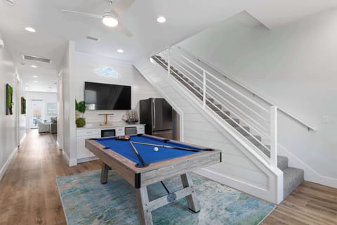 Indoor game area w/ pool table & open sightlines to surrounding spaces