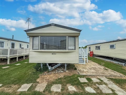 Cozy mobile home with bright windows and outdoor space