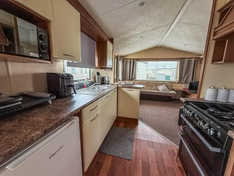 Cozy kitchen with scenic window views and open living area
