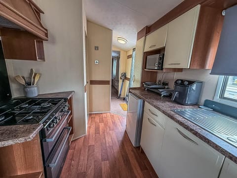 Cozy kitchen with modern appliances and warm wood floors