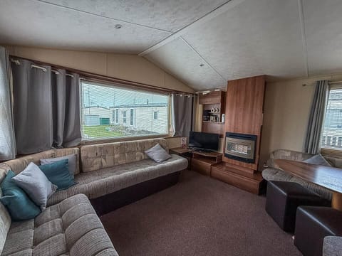Cozy living room with panoramic windows and fireplace