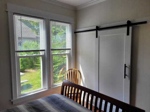 BEDROOM #1 (MAIN FLOOR):  Features a queen-size bed and its own private en suite full bathroom, dresser, nightstand, and closet.