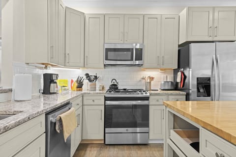 KITCHEN:  The home has a newly-renovated kitchen with a large kitchen island and all appliances, including a dishwasher.  There is also a good supply of cooking and dining utensils provided.