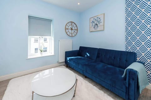 Enjoy this bright and stylish space featuring a plush sofa, smart dining setup, and a full kitchen—perfect for short or long stays. Free on-site parking included for added convenience.
