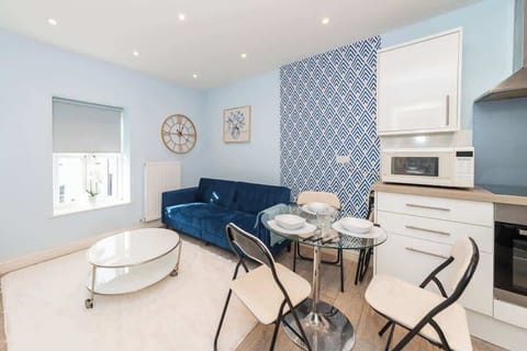 Enjoy this bright and stylish space featuring a plush sofa, smart dining setup, and a full kitchen—perfect for short or long stays. Free on-site parking included for added convenience.