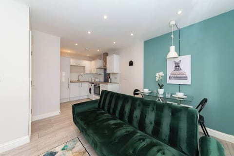 Bright and stylish living room area featuring modern decor a comfy area sofa, smart tv, and natural light perfect for relaxing after a day of exploring or working