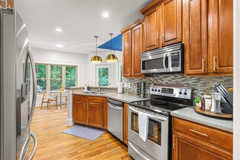 The kitchen features stainless steel appliances and elegant cabinetry.