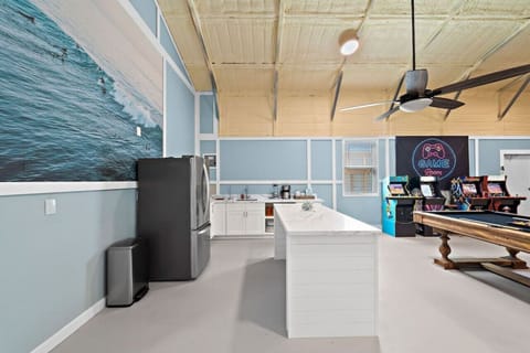 The gaming area comes complete with a fridge, sink, and counterspace to entertain while you wait for your turn at foosball.