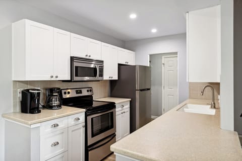 To your left from the entrance, a fully-equipped kitchen awaits, simplifying meal preparation.