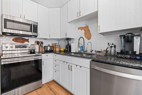 Fully stocked kitchen with cookware and prep space