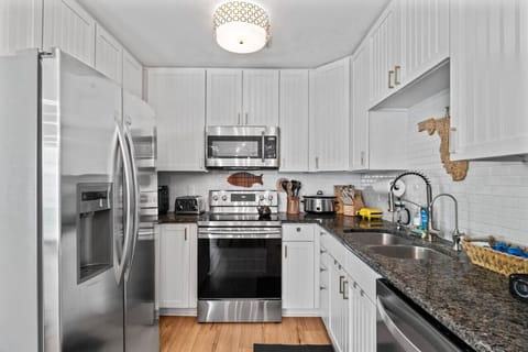 Updated kitchen with stainless steel appliances and bright cabinetry