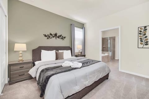Retreat to the spacious master bedroom featuring a luxurious ensuite bathroom and minimalistic decor. Enjoy comfort and style with a king-sized bed, ample natural light, and serene ambiance for a restful night's sleep.
