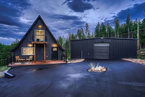 1. Stunning exterior at twilight, showcasing the home’s charm with ample parking space and breathtaking views. The soft glow of the evening sky enhances the inviting atmosphere, while the spacious parking area adds convenience. 