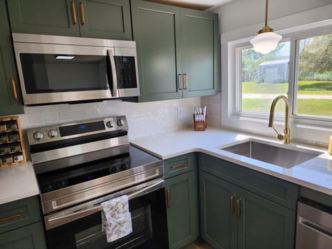 Kitchen with electric stove, microwave and dishwasher