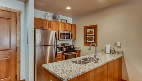 Compact kitchen with modern amenities and granite countertops.