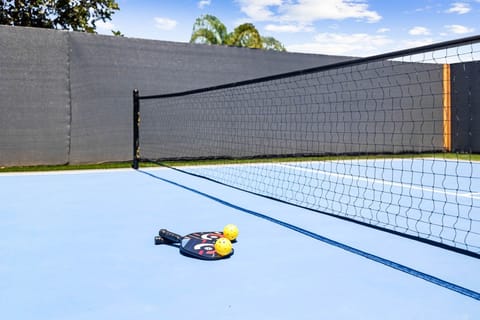Paddles and balls ready for a match on the private court.