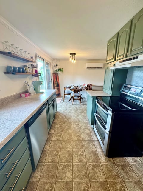 Kitchen view with dishwasher, double oven, double door fridge and more