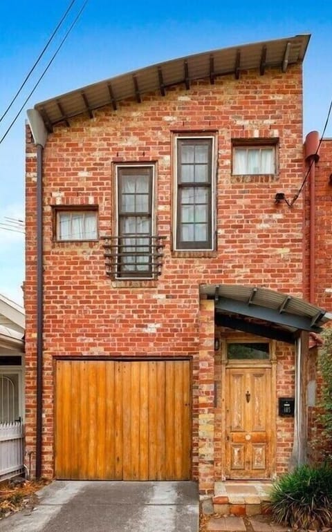 FRONT: The rustic warehouse style facade features recycled bricks and timbers.