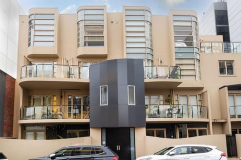 FRONT: The second floor, split level apartment is in a modern building on Wilson Street, South Yarra. It has a secure entrance, central light court and two undercover secure car spaces. 