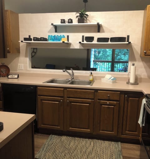 Kitchen open to dining and back yard view