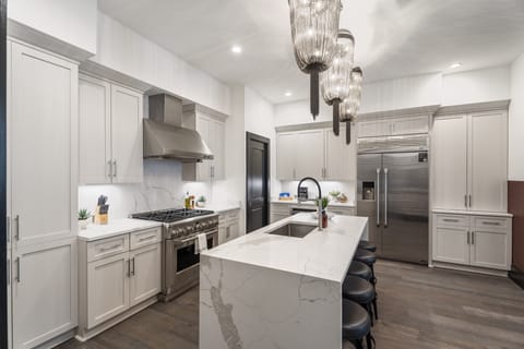 Cook or snack in style with a full kitchen featuring GE stainless appliances, cookware, and an island with bar seating. Ideal for short or extended stays, our kitchens make group travel in New Orleans easy and comfortable.