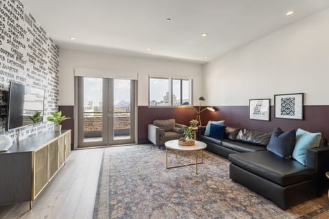 Relax in the living area with a smart TV, stylish seating, and a sleeper sofa for extra guests. Perfect for families or group stays in New Orleans, this inviting space is ideal for movie nights or recharging after a day in the city.