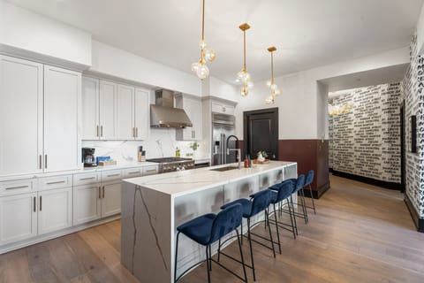 Cook or snack in style with a full kitchen featuring GE stainless appliances, cookware, and an island with bar seating. Ideal for short or extended stays, our kitchens make group travel in New Orleans easy and comfortable.