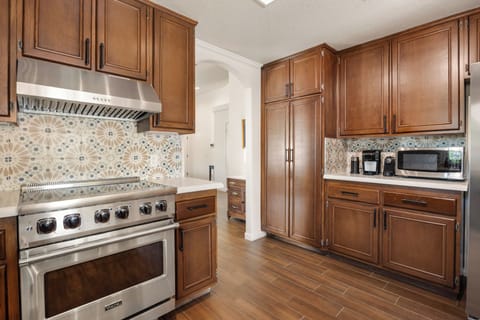 The kitchen features an induction cooktop, perfect for creating homemade meals.