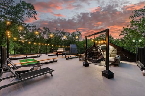 Pool table, putt putt, hot tub, corn hole, seating area, and swinging hammocks on the roof top level outside.