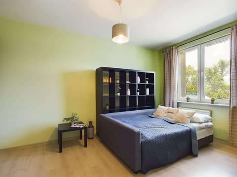 Bright studio with a large sofa bed – Cozy and practical setup for relaxing or sleeping.

