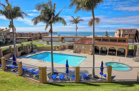 The sunny community pool is the heart of relaxation in the complex.