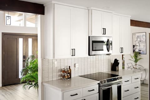 Whip up meals in the modern kitchen featuring stainless steel appliances, spacious counters, and plenty of light.