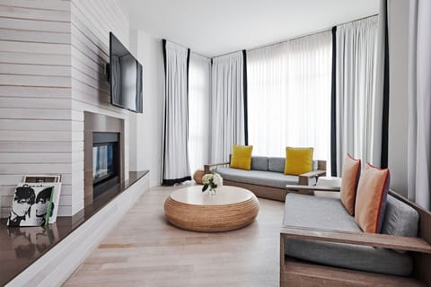 Gather by the fireplace in a sunlit lounge retreat.