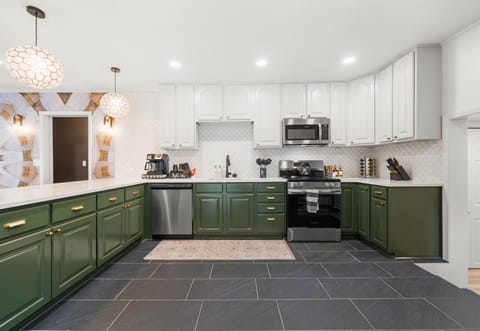 The sleek, spacious kitchen is ideal for both cooking and socializing, offering a perfect blend of form and function.